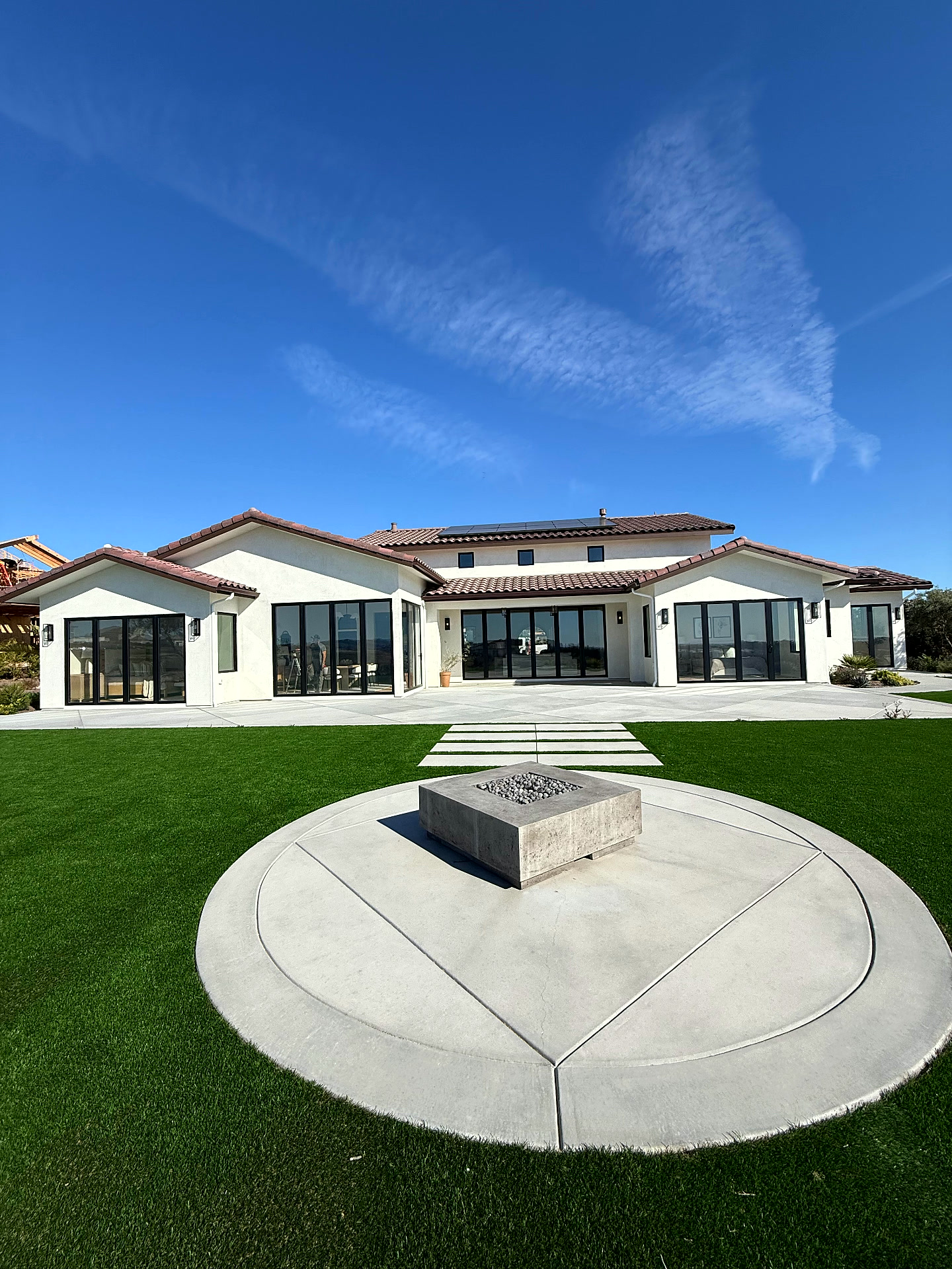 Luxury home with fully opened aluminum bifold doors at sunset